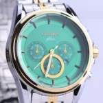 نمای نزدیک ساعت مچی سیتیزن مردانه فلزی نقره ای طلایی صفحه سبز G 2025-9/2